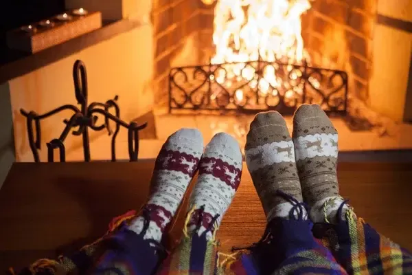 Depositphotos 317430724 stock photo man woman warm socks fireplace jpg